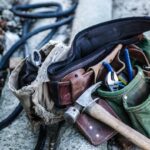 brown handled hammer and with tool belt